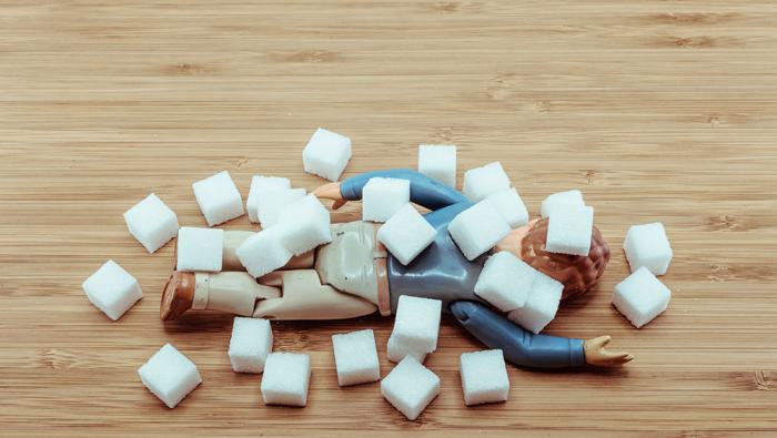 man doll under sugar cubes